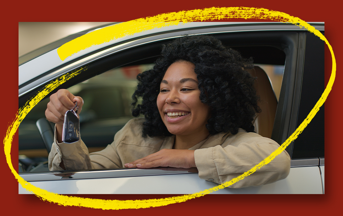 woman in car holding keys
